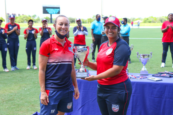 East captain Shebani Bhaskar accepts Best Batter award from USA Women's coach Julia Price waist up